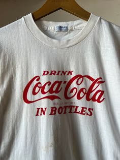 "1950s Coca Cola T-shirt. Has some staining on the front and the back, please refer to photos.  15.5\" Pit to Pit  25.5\" Length All sales final please ask any questions before buying - Thank you!" Vintage Coke Shirt, Vintage White T-shirt With Letter Print, Vintage Pre-washed Cotton T-shirt, Retro Crew Neck T-shirt Made In Usa, Retro Cotton T-shirt Made In Usa, Vintage Pre-washed Crew Neck T-shirt, Vintage Cotton Pre-shrunk T-shirt, Vintage Cotton Pre-washed T-shirt, Vintage Crew Neck T-shirt Made In Usa