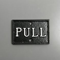 a black and white sign that says pull