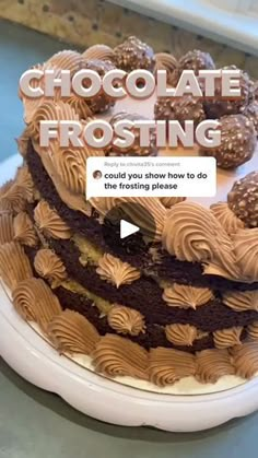 a chocolate frosted cake sitting on top of a white plate with the words chocolate frosting