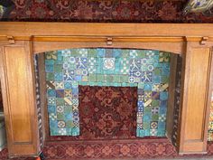 an old fireplace with colorful tiles on it