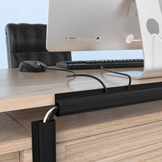 a computer monitor sitting on top of a wooden desk next to a keyboard and mouse