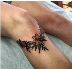 a woman's leg with flowers on it