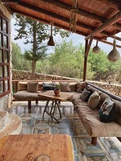 an outdoor living area with couches and tables