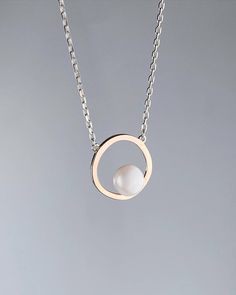 Our silver necklace is a refined combination of elegance and luxury. ✨ It has a delicate silver chain and a round gold-plated pendant, which will become a true highlight of any outfit. 🌟 The pendant is encrusted with a real pearl, adding a special charm and uniqueness to the jewelry. 💎 This necklace is perfect for those who appreciate classic beauty and modern style. Advantages of buying our necklace: 1. High-quality materials - silver and a real pearl. 🥇 2. Unique design that highlights your Pearl Gold Chain Design, Pearl Necklace Designs Unique, Modern Pearl Necklace, Single Pearl Pendant, Single Pearl Necklace, Natural Pearl Necklace, Gold Chain Design, Pearl Necklace Designs, Single Pearl