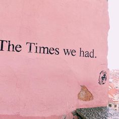 a pink wall with the words the times we had written on it and a clock tower in the background