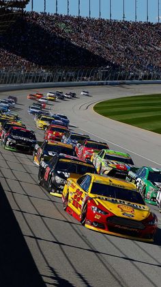 a group of cars driving down a race track