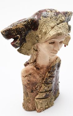 a sculpture of a woman with a hat on her head