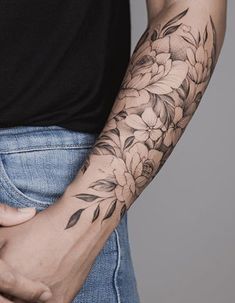 a man with a flower tattoo on his arm