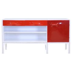 a red and white sideboard with two drawers on one shelf, the other closed