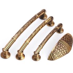 four different types of handles and knobs on a white background, one is gold