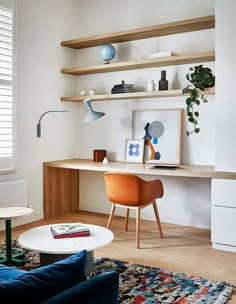 a living room filled with furniture next to a wall mounted book shelf on top of a hard wood floor