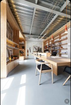 an empty room with wooden shelves and chairs