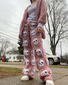 a woman in pink knitted pants with skulls on them