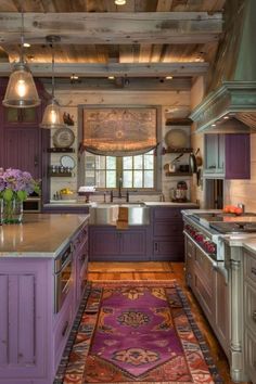 a kitchen with purple cabinets and an area rug