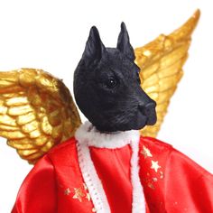 a black dog wearing a red coat and gold wings