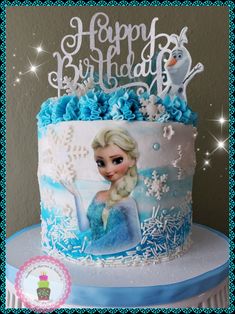 a frozen princess birthday cake with blue frosting