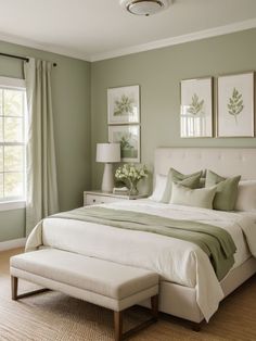 a bedroom with green walls and white bedding