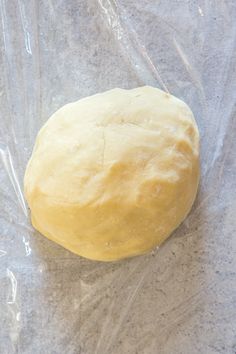 a ball of bread sitting on top of a plastic bag