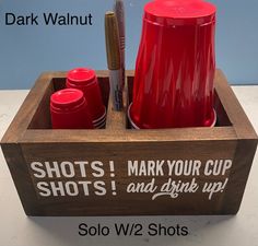 a red cup holder with two cups in it and the words shot's, mark your cup, and drink up