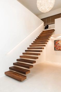 a wooden stair case in a white room