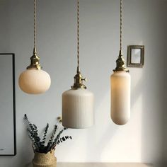 three light fixtures hanging from the ceiling in a room