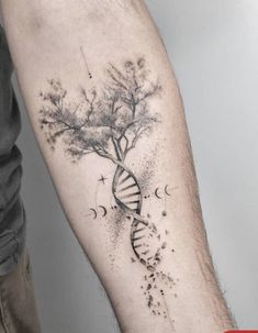 a man with a tattoo on his arm holding a tree and a spirally shaped object