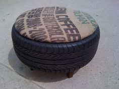 a close up of a tire covered ottoman on the ground with words written all over it