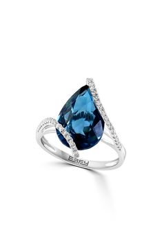 a blue and white ring with diamonds on it's sides, set in 18k white gold