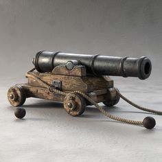 an old wooden toy cannon on wheels with two large binoculars attached to the top one