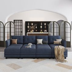 a large blue couch sitting in the middle of a living room next to an archway