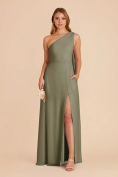 a woman in a green one shoulder dress