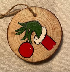 a wooden ornament with an image of a cherry on it