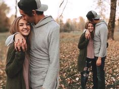 two people hugging each other while standing in leaves