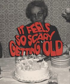 an older woman blowing out candles on a birthday cake with the words it feels so scary getting old