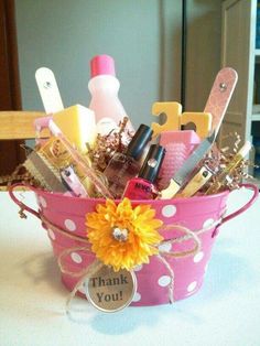 a pink polka dot bucket filled with lots of personal care items and some yellow flowers