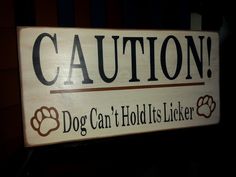 a sign that says caution dog can hold's licker