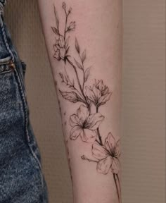 a black and white flower tattoo on the arm