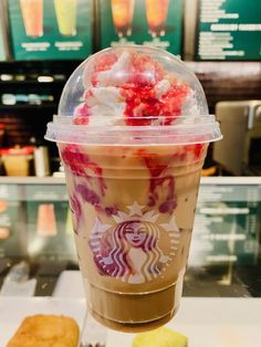 a starbucks drink with strawberries and whipped cream