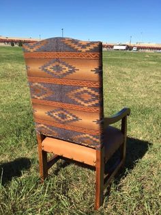 an old wooden chair sitting in the grass