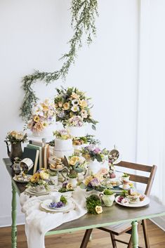 a table topped with lots of food and flowers