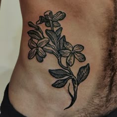 a close up of a person's stomach with flowers on it