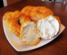 some fried food on a white plate with cream in between it and two other items