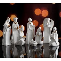 a group of white figurines sitting next to each other on top of a table