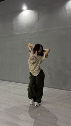 a woman standing on top of a hard wood floor