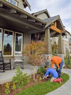 a man in an orange shirt is working on a porch