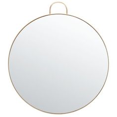 a round mirror hanging on the wall