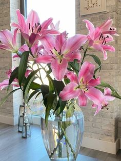 a vase filled with pink flowers on top of a table