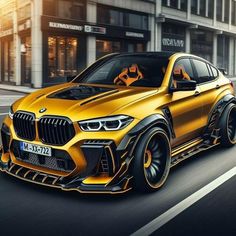 a yellow bmw suv is driving down the street