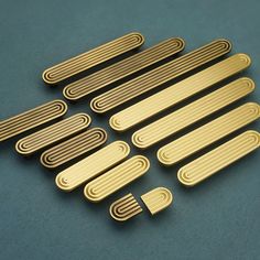 brass plated metal strips on a blue surface with one side cut out and the other half closed