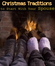 two people wearing socks and slippers sitting in front of a fire place with their feet up